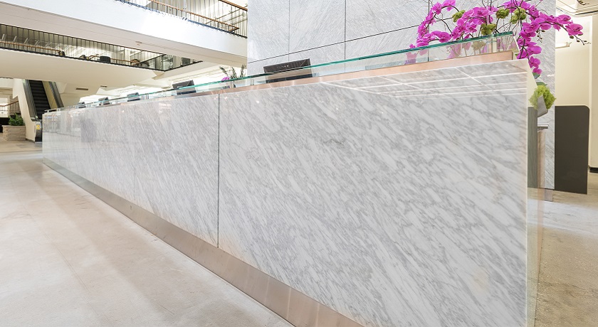 a Carrara marble worktop and a wall in a reception area