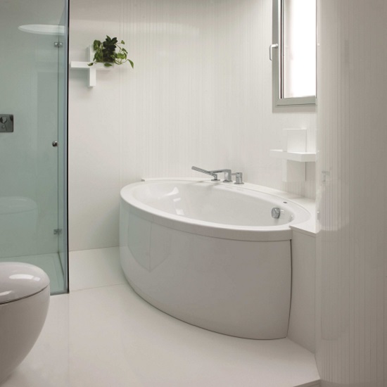 a white bathroom with a Compac Absolute Blanc bath tub, walls, and floors