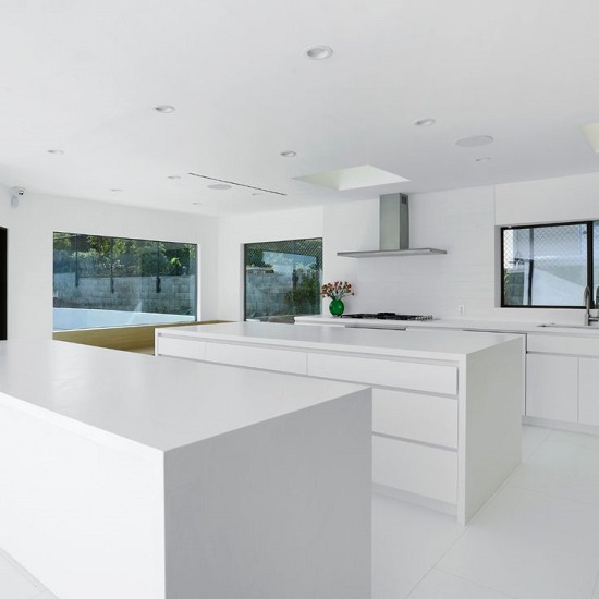 a minimalistic kitchen with Compac Absolute Blanc countertops