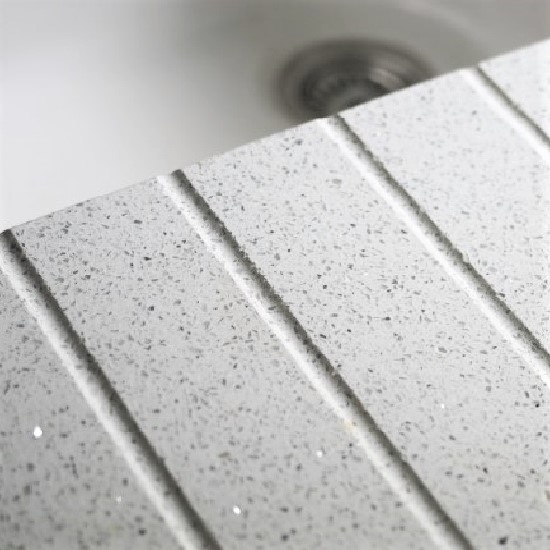a close-up photo of a Compac Astral Lactea worktop with a set of draining grooves