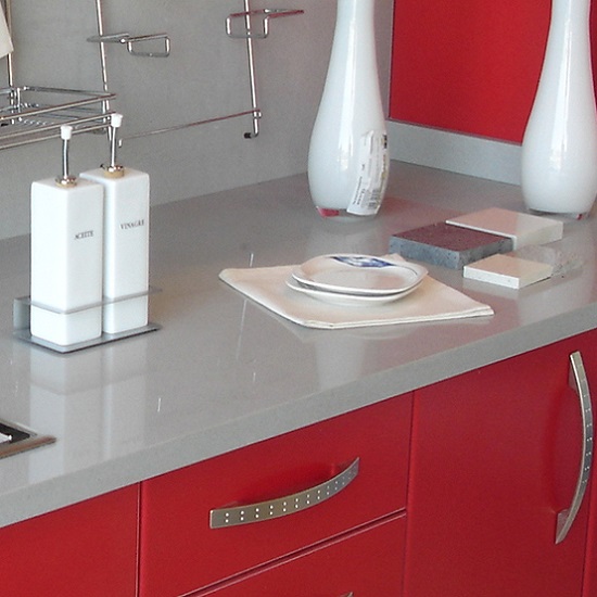 a photo of a kitchen with Compac Ceniza worktop and red cabinets