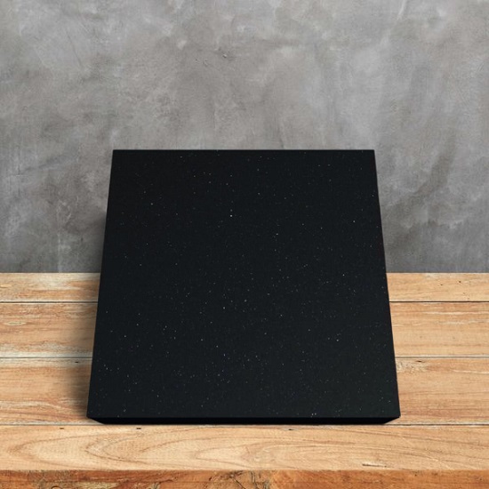 a photo of a Compac Nocturno sample and a grey wall behind