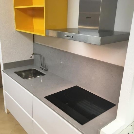 a photo of a kitchen with worktops and matching Compac Volcano Grey backsplashes