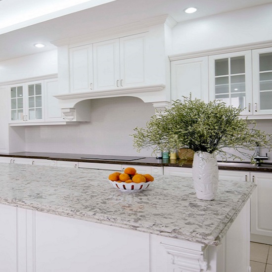 a kitchen with Unistone Alaska White quartz worktops