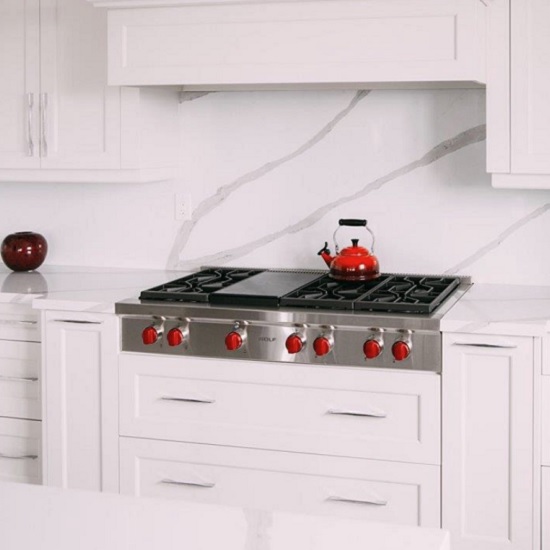 a photo of Unistone Arabescato worktops and splashbacks in a white kitchen