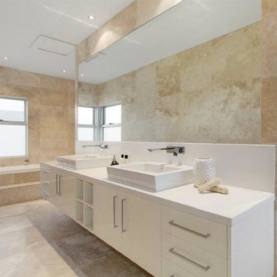 a photo of a Unistone Bianco Extra quartz vanity top in a bathroom