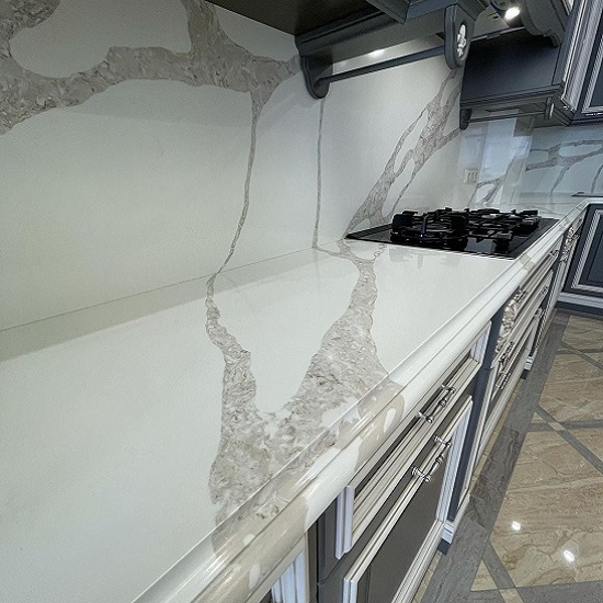 a photo of a kitchen with Unistone Calacatta Vagli Oro quartz 3 cm thickness