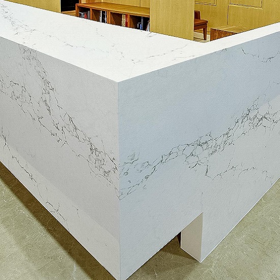 a desk with Unistone Statuario quartz surfaces