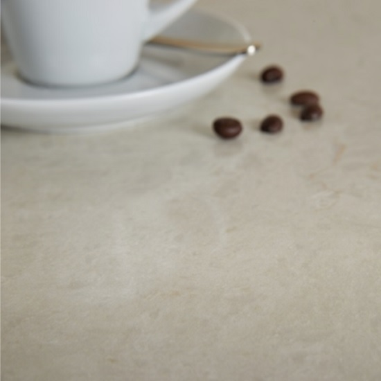 a Unistone Taj Mahal kitchen worktop and a coffee cup and coffee beans on its surface