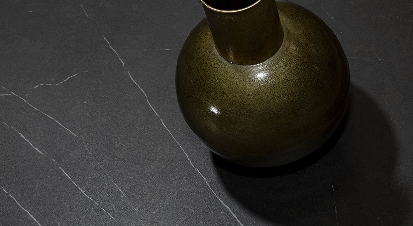 a black Ascale Allura Black worktop with a golden vase on its surface