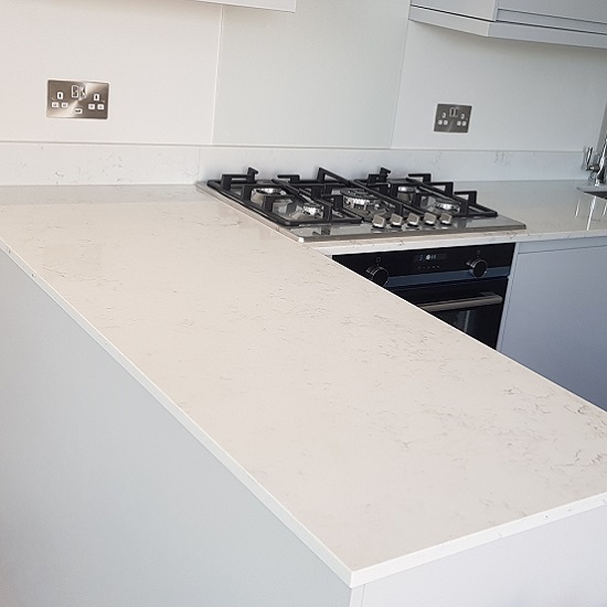 a photo of a kitchen with Nile Quartz Carrara worktops