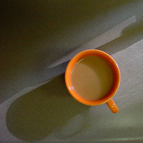 a Nile Quartz Grigio Starlight worktop and an orange coloured cup viewed from above