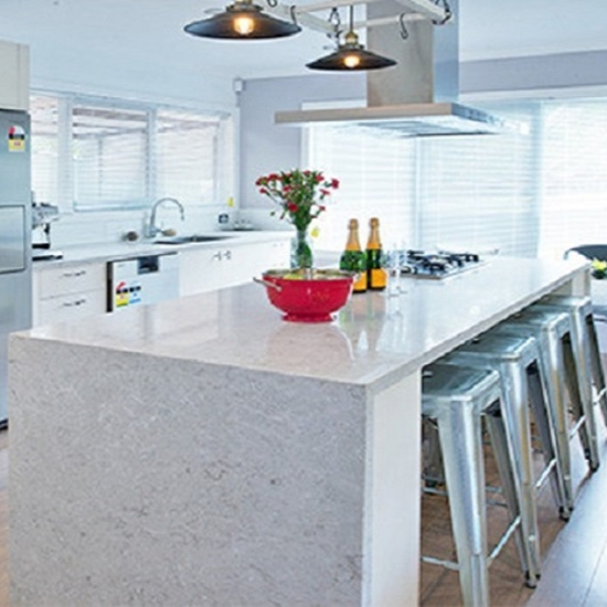 a kitchen with a Caesarstone Bianco island worktop