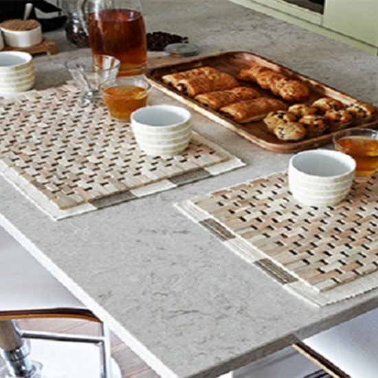 a Caesarstone Bianco Drift table top with food and cutlery on it