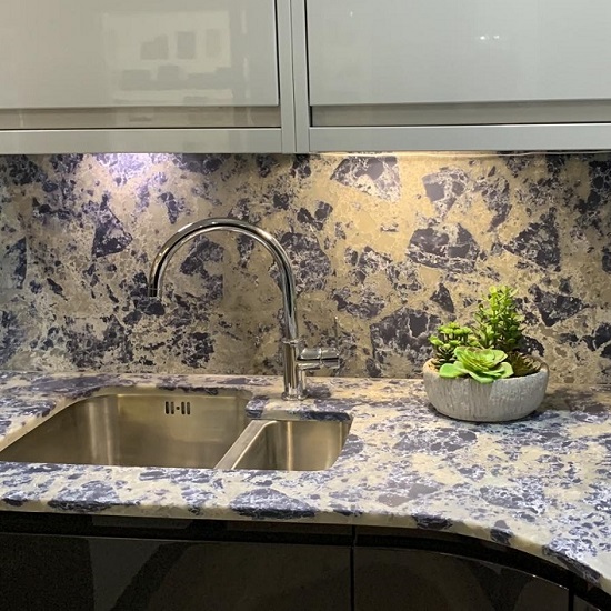 a white kitchen with Nile Quartz Blue Lagoon work surfaces