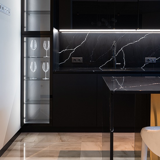 a Nile Quartz Marquina Shimmer worktop and matching backsplash in a black kitchen