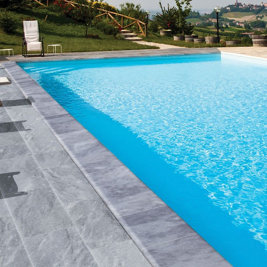 a swimming pool with Mystic Grey marble tiles