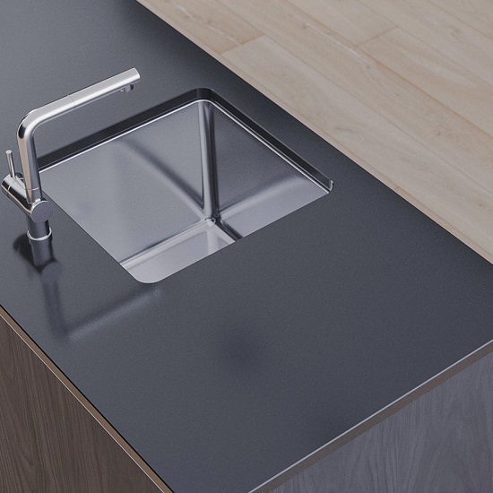a photo of a Technistone Crystal Vulcano kitchen island with a stainless steel sink and tap