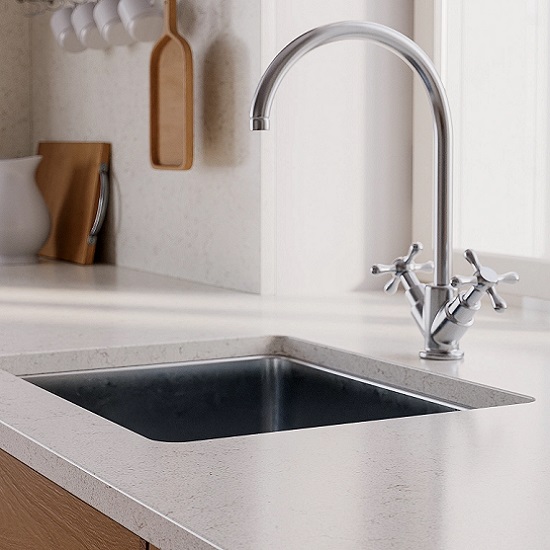 a photo of a Technistone Noble Vintage worktop, a sink, a tap and kitchen accessories hanging in a wall behind