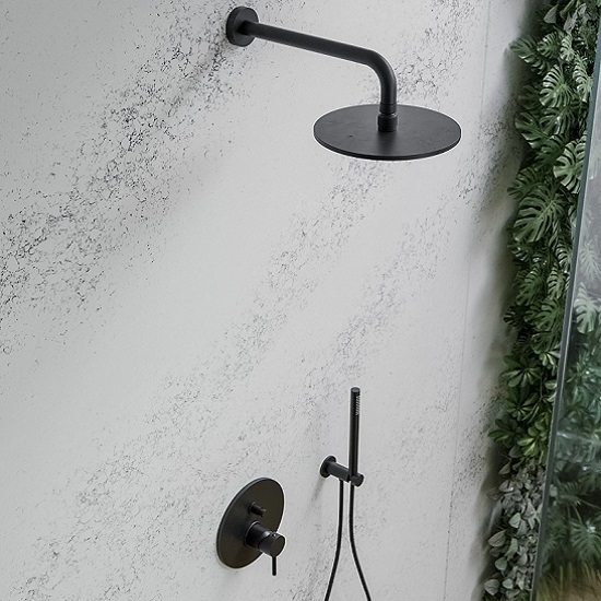 a photo of Technistone Pearl Alba in a bathroom shower wall, a shower head a two levers