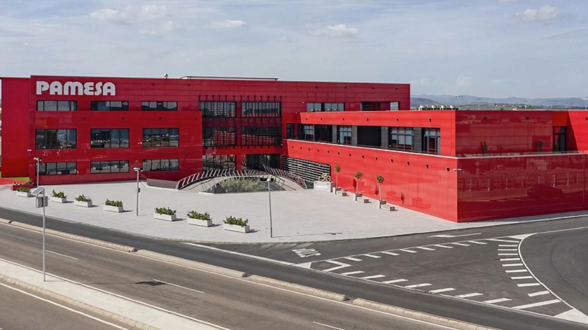 A photo of two red buildings belonging to Ascale Tau's Pamesa Ceramic Groups 