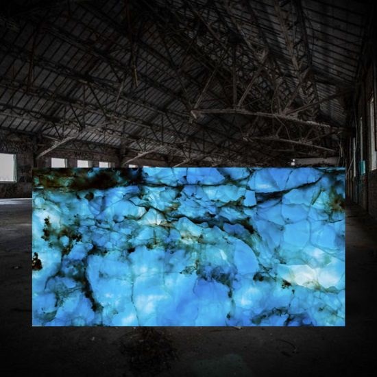 a photo of a Blue Onyx backlit slab inside a warehouse