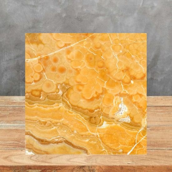 an image of a Honey Onyx sample on a table and a grey background