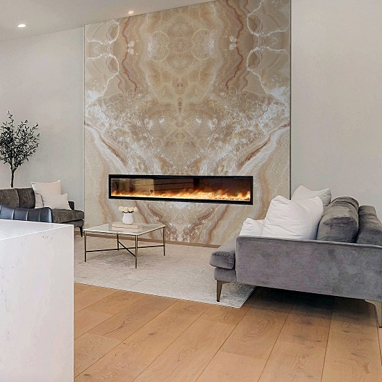 a photo of a living room with a Honey Onyx fireplace surround a sofa and a plant
