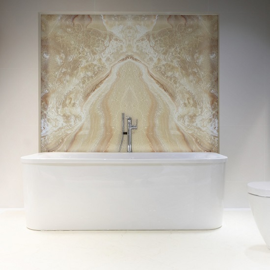 a photo of a minimalistic white bathroom and a stand alone tub with a wall cladding in Honey Onyx behind