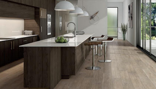 A kitchen with a white island and stools