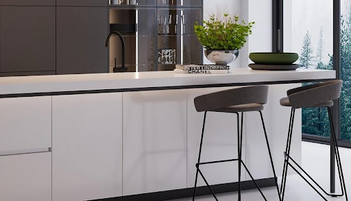 A white counter with a stool and a plant on it