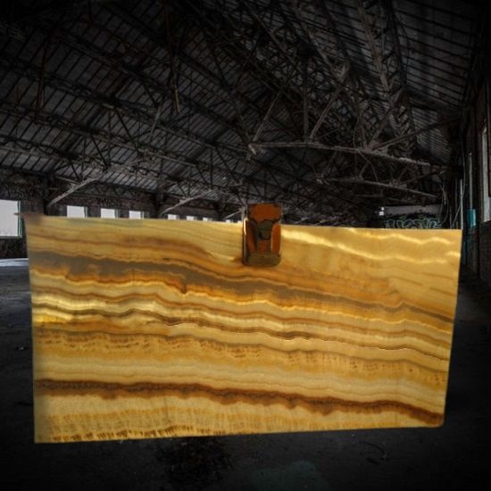 an image of a Techlam Agatha Caramel slab backlit in a dark warehouse
