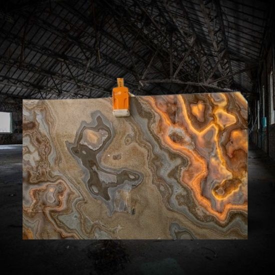 a Brown Onyx slab with vibrant colours in a dark warehouse