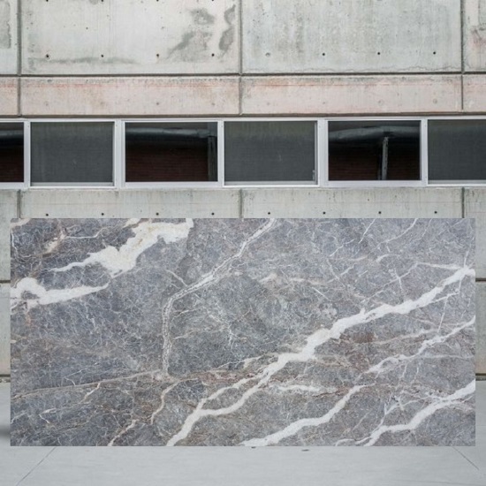 an image of a Fiori Di Pesco Carnico marble slab outside a stone yard