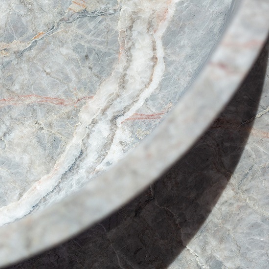 a close-up photo of a Fiori Di Pesco Carnico honed marble basin