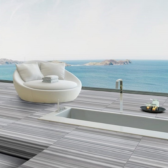 an open plan living room with Marmara marble floors and a sea-view behind