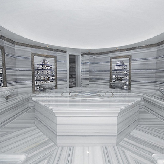 a white room with Marmara Marble floor tiles and walls