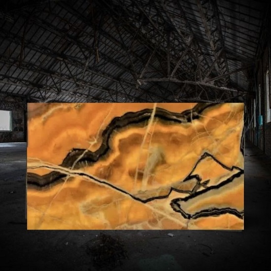 an image of a backlit Orange Onyx slab in a dark warehouse