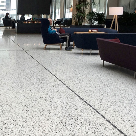 a photo of a hotel lobby with grey Terrazzo Moncervetto tiles