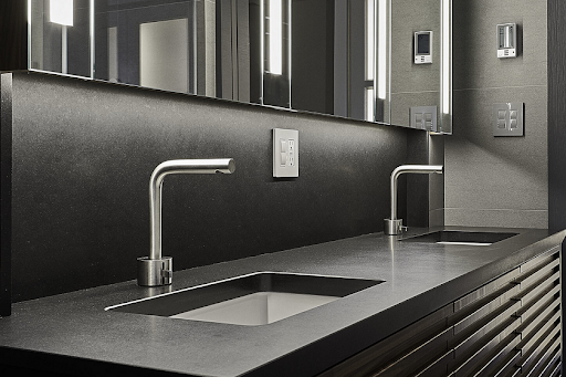 a Quartzforms QF Black Quartz worktop and two stainless steel taps