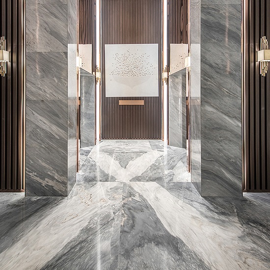 a luxurious entrance with a Palissandro Nuvolato Marble wall