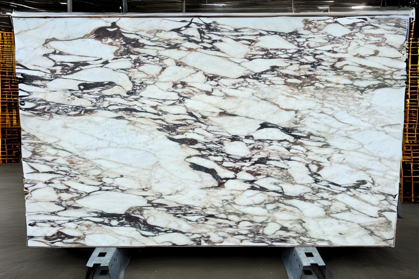 a photo of a Calacatta Viola Marble slab inside a warehouse