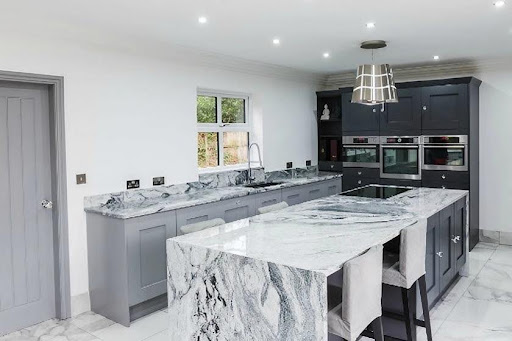 A kitchen with Viscount White Granite worktops and grey cabinets