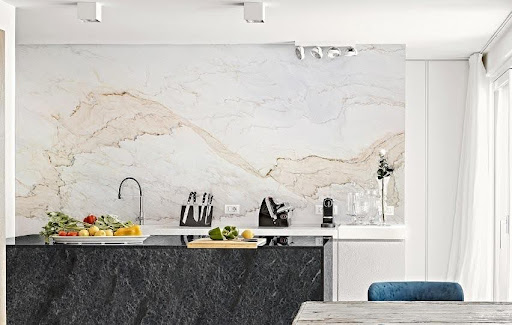 A white kitchen with Palissandro Marble worktops and backsplashes, and a black granite island