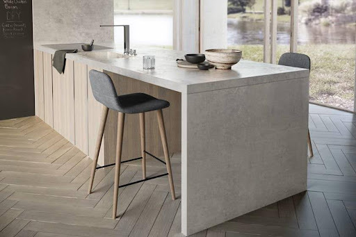A kitchen with a bar stool