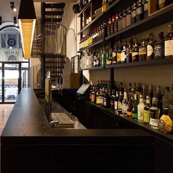 a roman travertine splashback in a bar