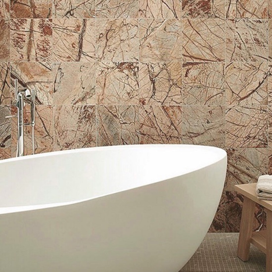 a wall covering in Rainforest Brown Marble and a white bath tub