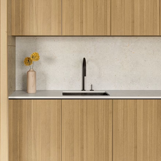 a wooden kitchen with Dekton Polar countertops and matching splashback