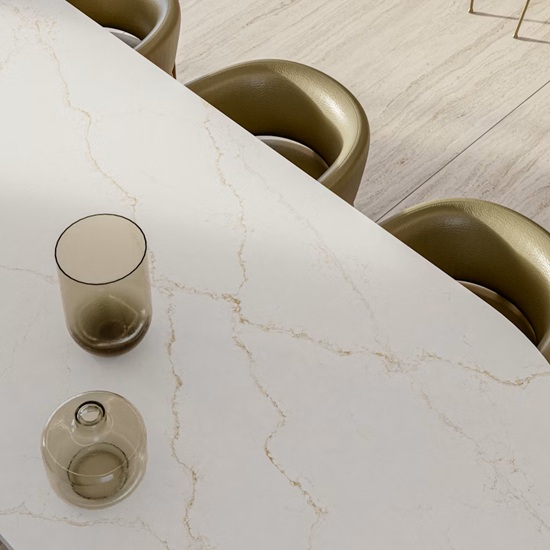 a Silestone Blanc Elysee worktop and three golden chairs