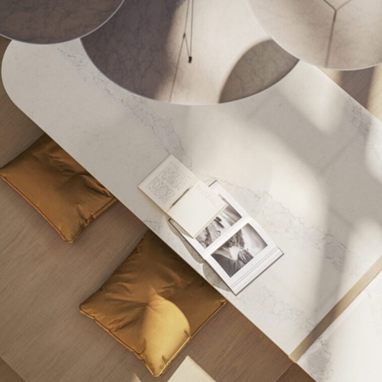 a Caesarstone Calacatta Stillstorm worktop, a magazine and two cushions